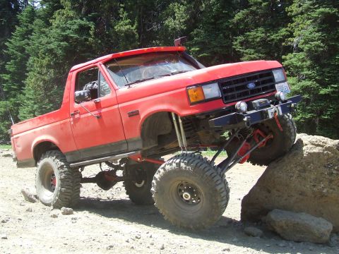 1979 Ford Bronco - This lifted 1987 Ford Bronco navigates a rocky trail, its off-road capabilities.