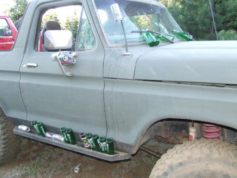1979 Ford Bronco - This Ford Bronco has a unique way of storing beverages, with bottles lining the running board and windshield wipers.