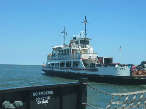 1985 Ford LTD Crown Victoria - The Hatteras ferry transports vehicles and people across the water on a sunny day.