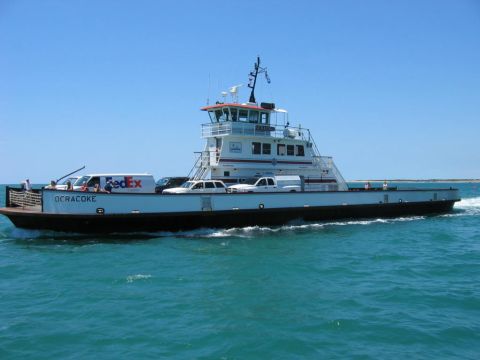 1985 Ford LTD Crown Victoria - The Ocracoke ferry transports vehicles across the water on a sunny day.