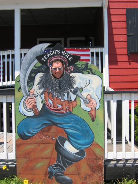 1985 Ford LTD Crown Victoria - A person poses in a pirate-themed cutout at a tourist spot.