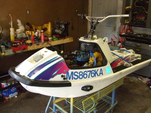 1998 Kawasaki JH1100-A4 1100 ZXi - Personal watercraft with registration number MS8676KA sits in a garage with tools and engine parts visible.