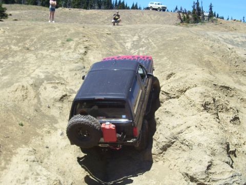 1989 Ford Bronco - This 1989 Ford Bronco is tackling a challenging off-road course with a second Bronco visible in the background.