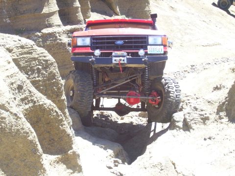 1989 Ford Bronco - This modified 1989 Ford Bronco is navigating a rocky trail, its off-road capabilities.