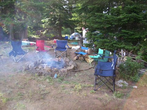 1989 Ford Bronco - A group of people enjoy a campfire in a natural setting, likely a campground or park.