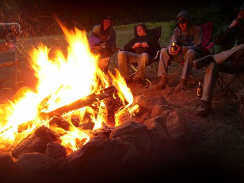 1989 Ford Bronco - Friends enjoy a warm campfire gathering in an outdoor setting.