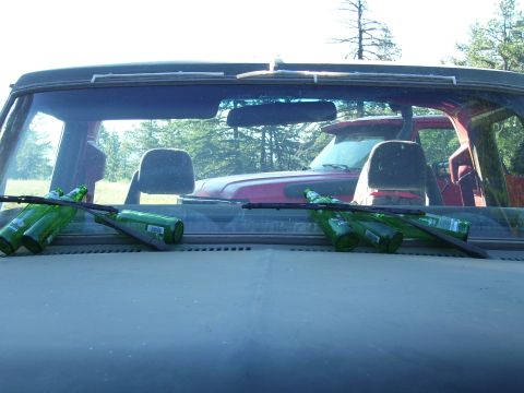 1989 Ford Bronco - Interior view of a 1989 Ford Bronco, with green bottles resting on the hood.