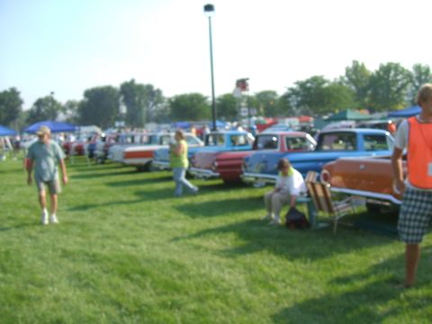 1974 Ford Ranchero - Cars lined up on a grassy field at what appears to be a car show or outdoor gathering.