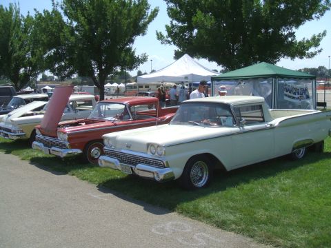 1974 Ford Ranchero - Several classic vehicles are lined up on display at an outdoor event.