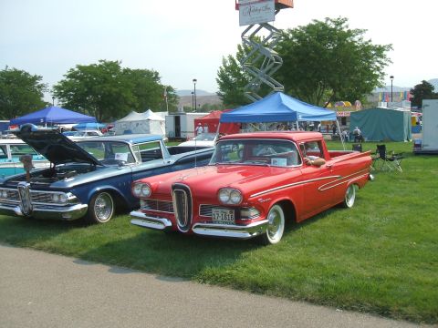1974 Ford Ranchero - Two classic pickup trucks, a red 1958 Edsel and a blue 1959 Ford, displayed at an outdoor event.