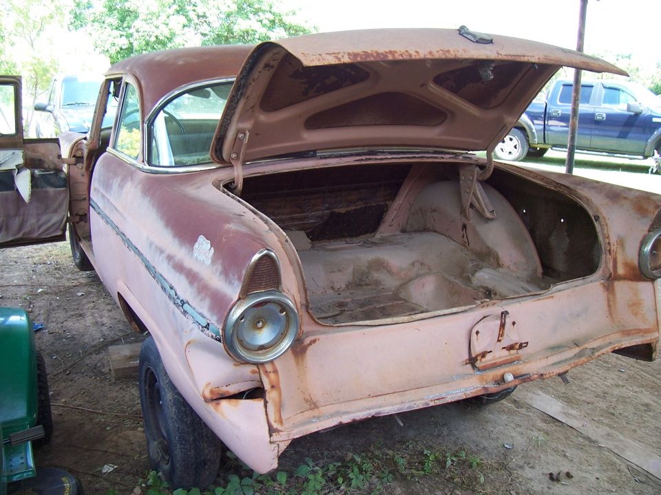 1955 Ford Customline with open trunk, showing rust and wear