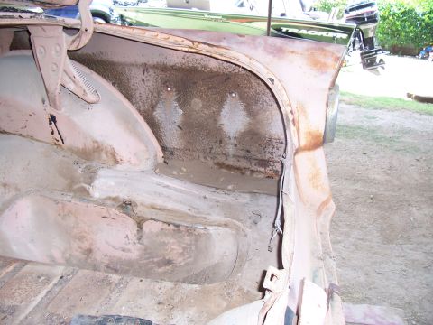 1955 Ford Customline - The trunk interior of a 1955 Ford Customline shows significant rust and wear, indicating a need for restoration.