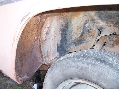 1955 Ford Customline - The wheel well and tire show significant rust and wear, indicating a need for restoration.