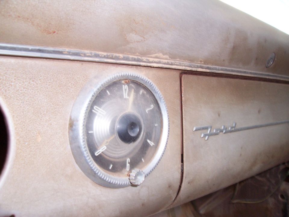 1955 Ford Customline dashboard clock and Ford emblem