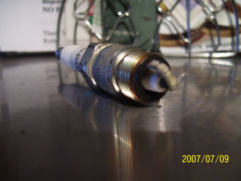 Spark plug with visible text on the side