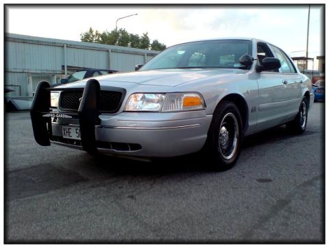 1998 Ford Crown Victoria - A silver 1998 Ford Crown Victoria is shown from a three-quarter front view, equipped with a protective bull bar.