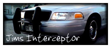 1998 Ford Crown Victoria - This 1998 Ford Crown Victoria features a prominent push bar and custom text on the lower grille area.
