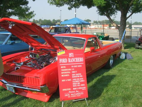 1974 Ford Ranchero - A red 1971 Ford Ranchero is displayed at a car show with its hood open.