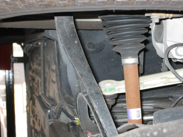 Underside CV boot and shaft with copper section and purple barcode label near control arm