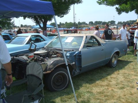 1974 Ford Ranchero - A light blue Ford Ranchero is displayed with its hood open, revealing the engine compartment.
