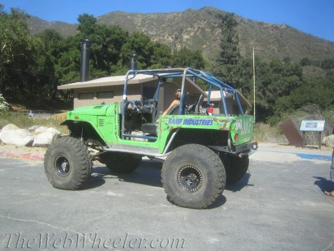 1987 Suzuki Samurai - This heavily modified vehicle is parked in a scenic outdoor location.