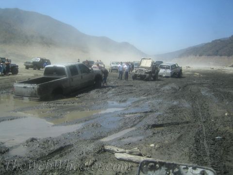 1987 Suzuki Samurai - Multiple vehicles are stuck in the mud during an off-road excursion.