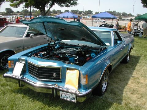 1972 Ford Ranchero - A blue 1972 Ford Ranchero is displayed with its hood open, revealing the engine and front grille.