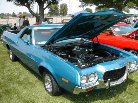 1972 Ford Ranchero - A blue 1972 Ford Ranchero is displayed with its hood open, revealing the engine bay.