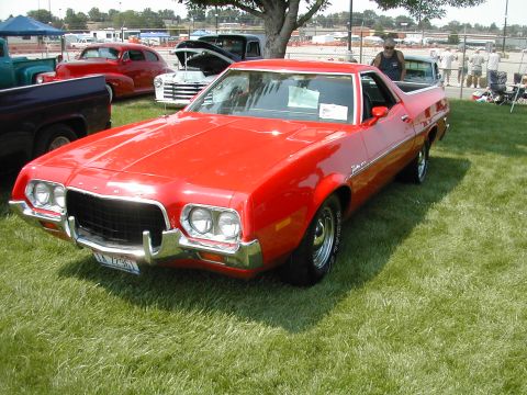 1972 Ford Ranchero - A red 1972 Ford Ranchero is displayed at an outdoor event with other classic cars visible.