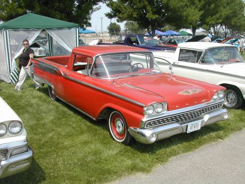 1972 Ford Ranchero - A red 1959 Ford Ranchero is displayed at an outdoor car show with other vehicles and tents.