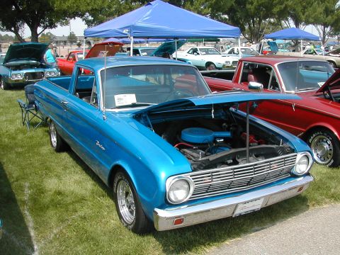 1972 Ford Ranchero - A blue Ford Falcon Ranchero is displayed at a car show, with its hood open to reveal the engine.