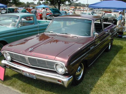 1972 Ford Ranchero - A maroon Ford Falcon Ranchero is parked on a grassy field at an outdoor car show.