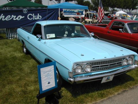 1972 Ford Ranchero - Light blue Ford Ranchero at a car show, with a red Ranchero behind it and club banners.