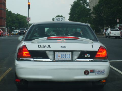 2004 Ford Crown Victoria - This white taxi features a spoiler and a Washington D.C. license plate.