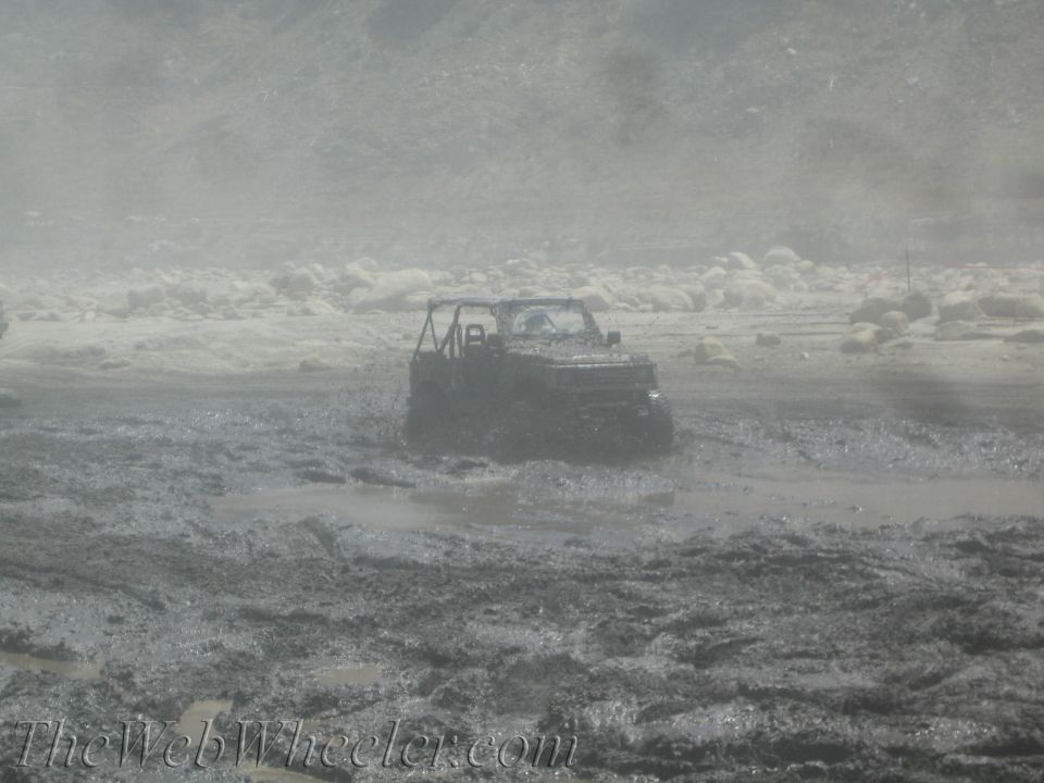 1987 Suzuki Samurai stuck in deep mud, front view