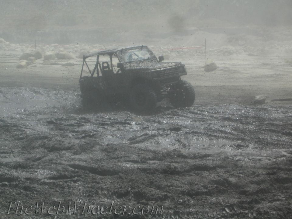 1987 Suzuki Samurai driving through mud