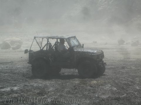 1987 Suzuki Samurai - This vehicle is covered in mud while navigating a challenging off-road terrain.