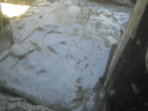 1987 Suzuki Samurai - Close-up of a muddy, textured surface with visible ripples and debris.