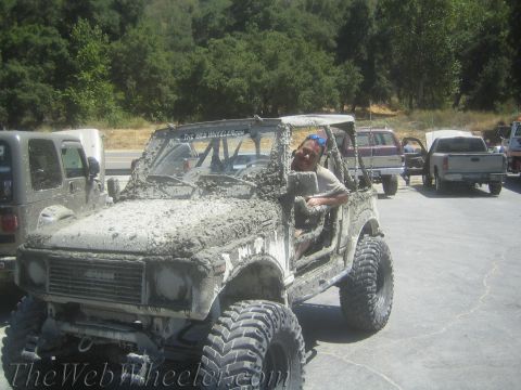 1987 Suzuki Samurai - Mud-caked 1987 Suzuki Samurai parked with other off-road vehicles after an outing.