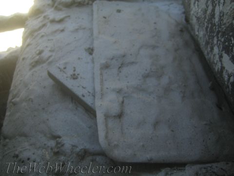 1987 Suzuki Samurai - A close-up view of a concrete structure with a triangular metal piece partially embedded within it.