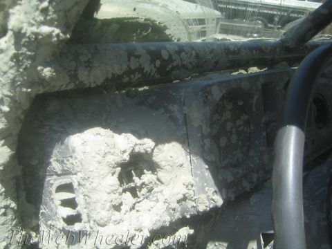 1987 Suzuki Samurai - Vehicle interior heavily covered in mud, obscuring details.