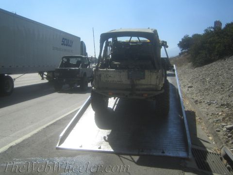 1987 Suzuki Samurai - Suzuki Samurai being towed on a flatbed truck, with a semi-truck and another Samurai visible.