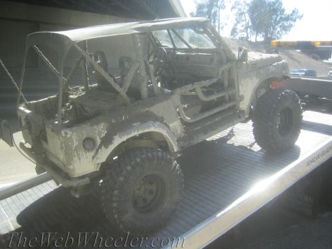 1987 Suzuki Samurai - This heavily soiled vehicle is being transported on a flatbed tow truck.