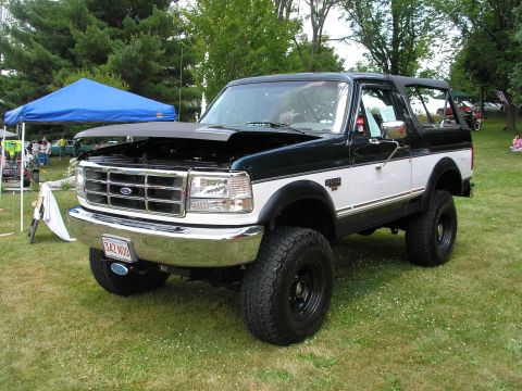 1994 Ford Bronco - This two-tone 1994 Ford Bronco is displayed with its hood open at an outdoor event.