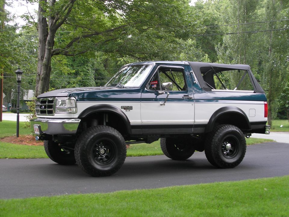 1994 Ford Bronco, two-tone green and white, soft top, lifted
