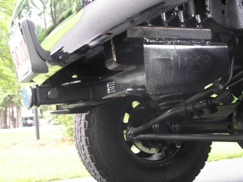 1994 Ford Bronco - Rear view of a vehicle's trailer hitch assembly and bumper detail.