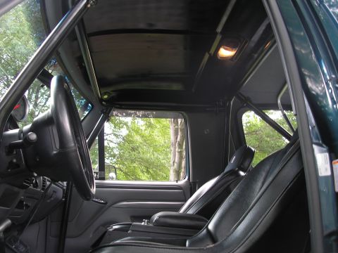 1994 Ford Bronco - Interior view of a 1994 Ford Bronco, highlighting the roll cage and seating.