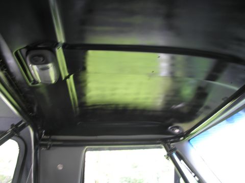 1994 Ford Bronco - The interior roof of a vehicle is visible, showing a black headliner and a light fixture.