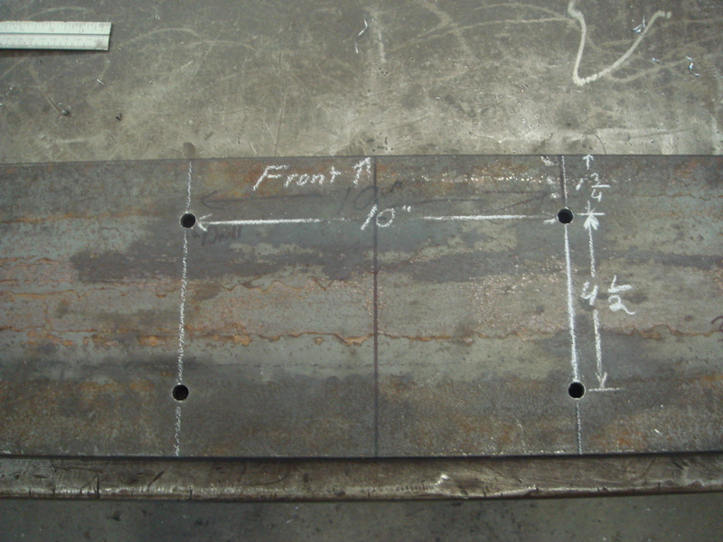 Metal plate with chalk markings for drill holes, labeled 'Front', 10" spacing, 4 1/2" and 3/4" measurements
