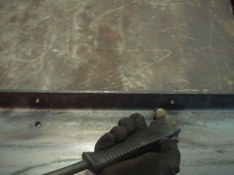 1996 Ford Bronco - A gloved hand grips a tool, poised to work on a scratched metal surface, possibly during a winch installation.